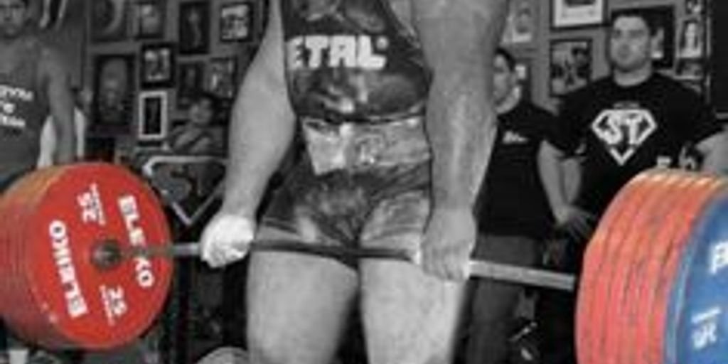 muscular man lifting weights